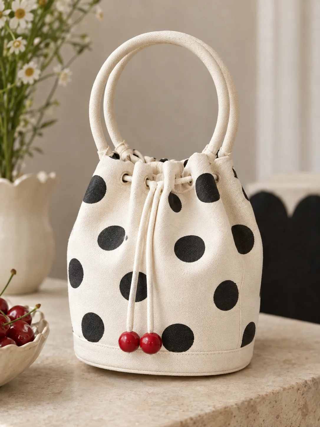Coin Dot Bucket Mini, close-up: the drawstring and red stoppers