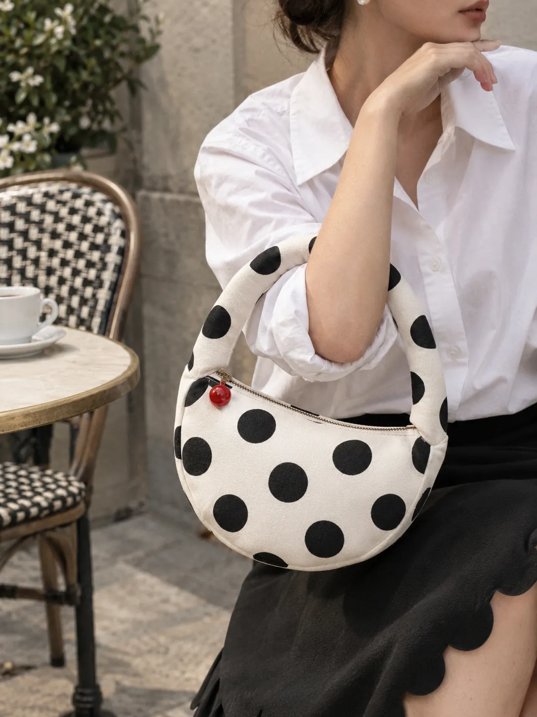 Half Moon Pouch Bag in milk with ink dots, in use