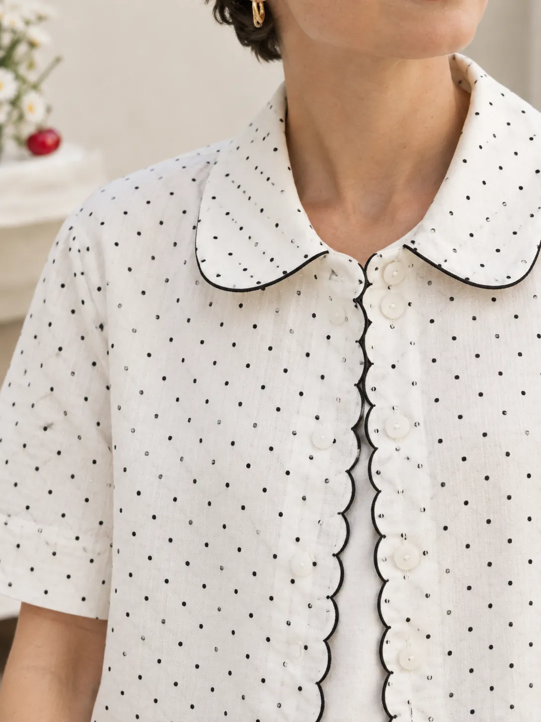Scallop Placket Shirt, close-up: the scalloped placket edge and round buttons