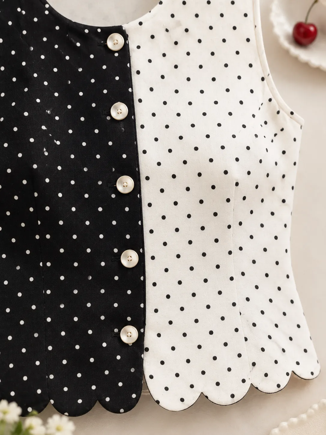 Split Dot Vest Top, close-up: the split centre front and scalloped hem