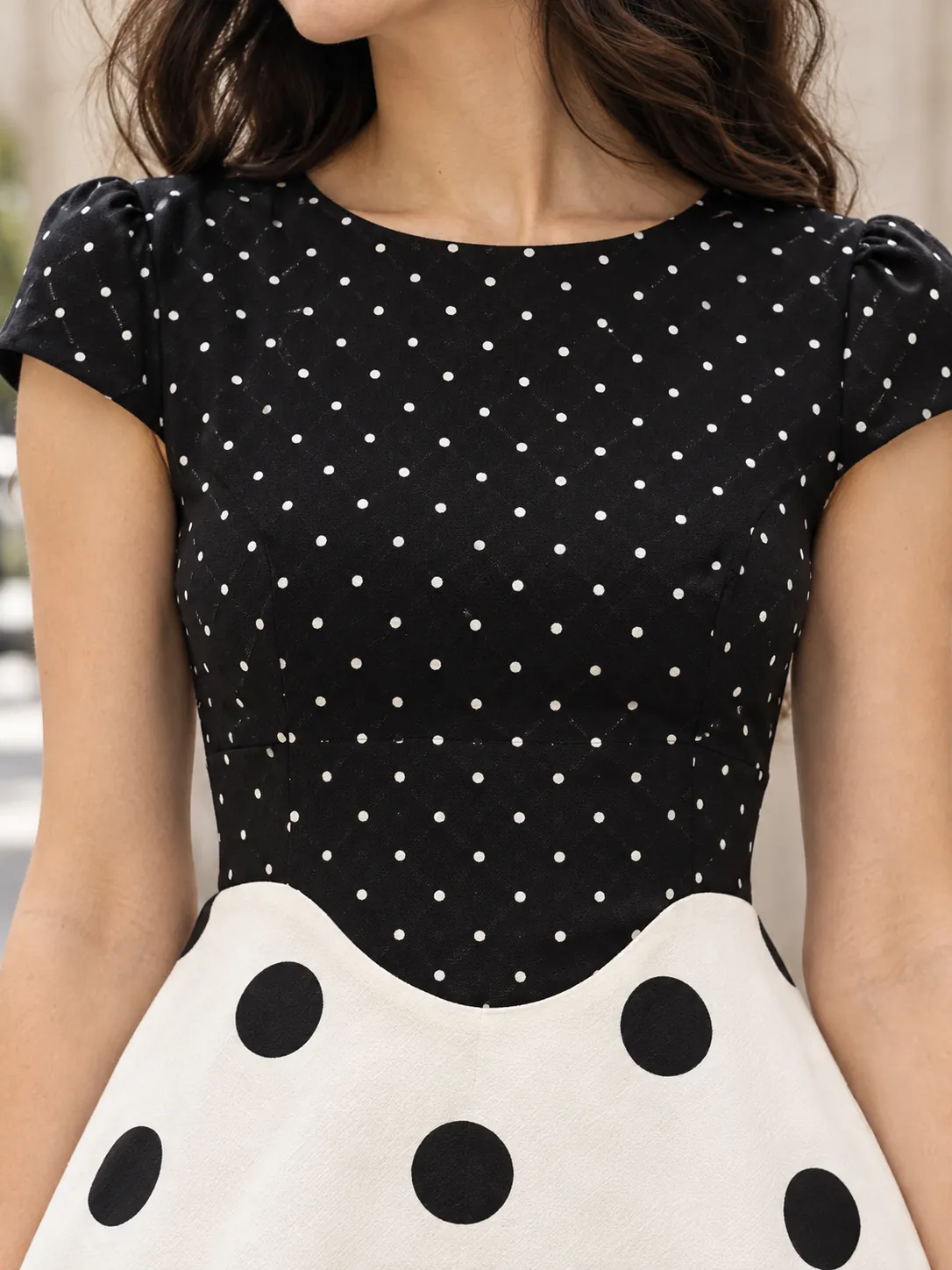 Two-Dot Panel Dress, close-up: the curved seam where the pin-dot bodice meets the coin-dot skirt
